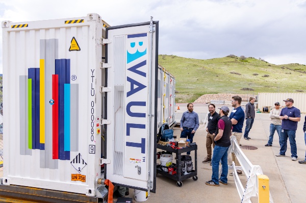 people standing outside a battery energy storage system