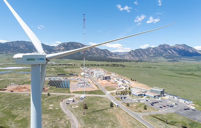 Aerial view of NREL's Flatirons Campus with a wind turbine in the foreground