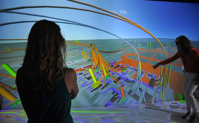 Two researchers evaluate a 3D visualization of an energy system.