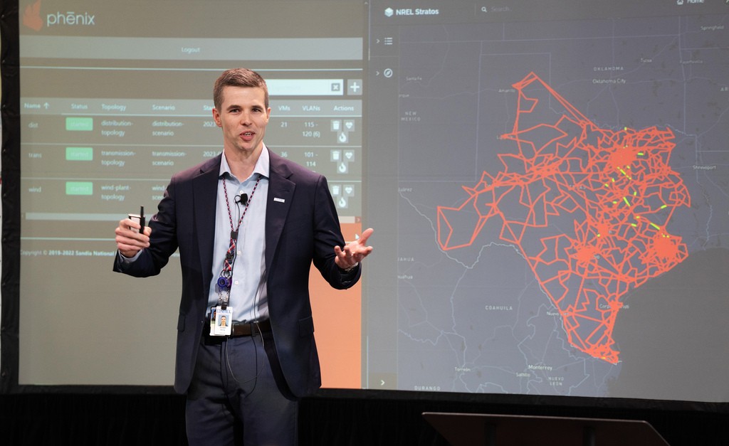 Photo of a person giving a presentation with a map of data on a screen behind them