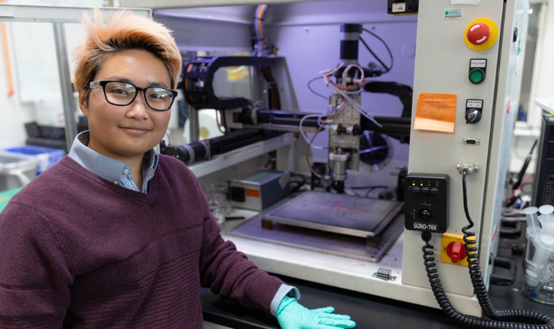 Person stands in front of lab equipment