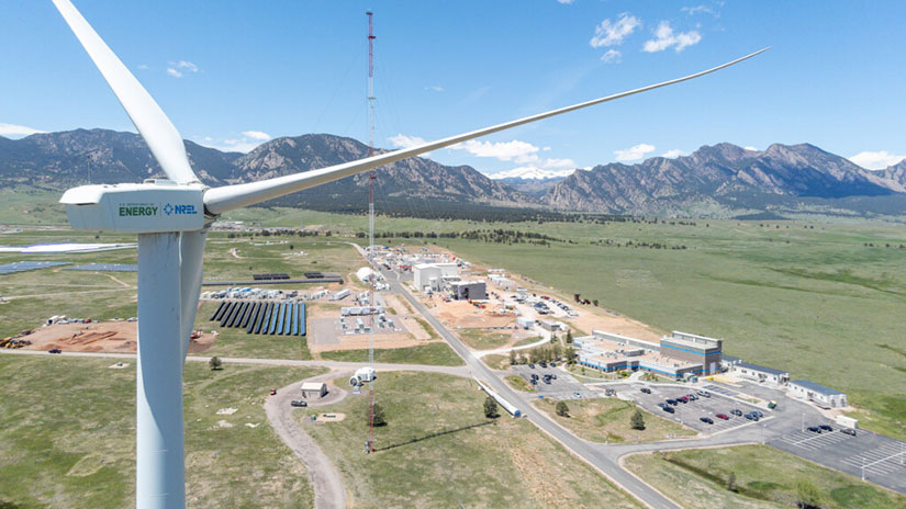 Aerial view of flatirons campus with wind turbine blades in the foreground