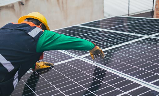 pexels-los-muertos-crew-8853502 Photo of a person installing rooftop solar on a house.