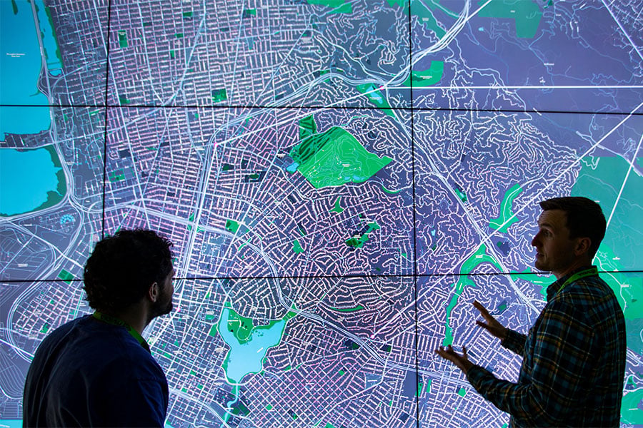 Researchers discuss a large map.