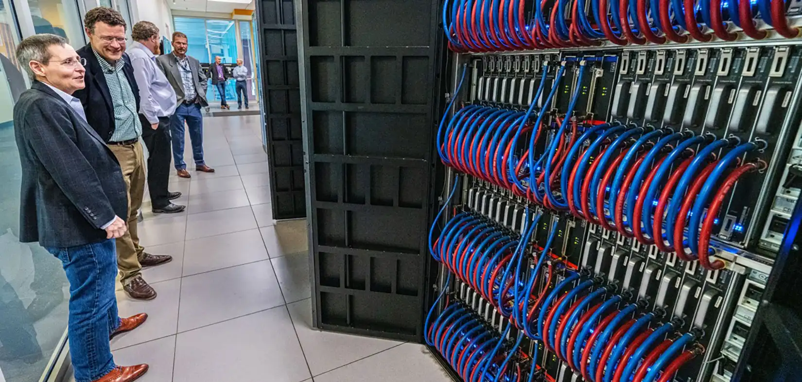 ici-hero-full A large crane lowering a structure with a worker in the foreground.