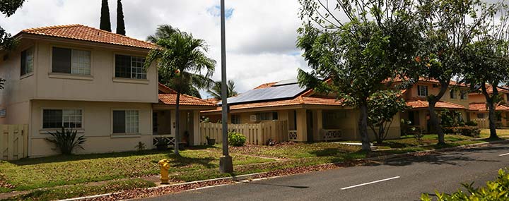 Photo of a home with a rooftop solar system in a residential neighborhood in Hawaii.