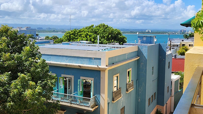 Aerial view of Puerto Rico ocean coastline with the rooftops of colorful buildings