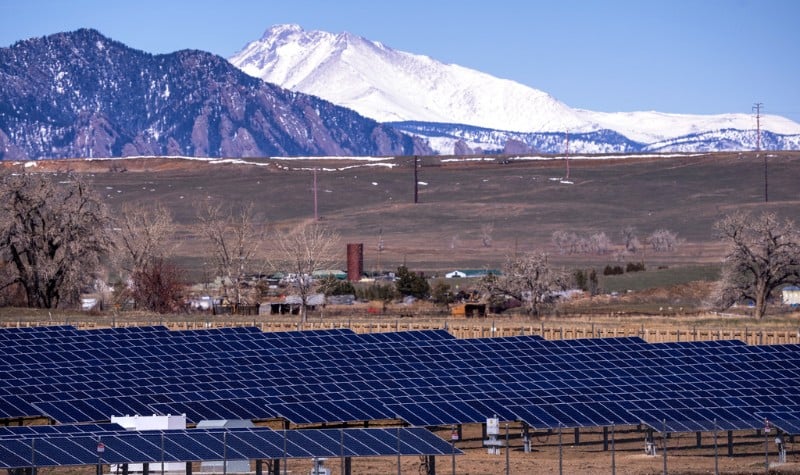 Solar panel array with mountains in the background