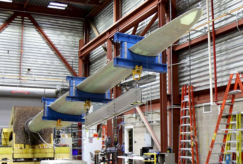 A thermoplastics wind turbine blade undergoing testing at NREL.