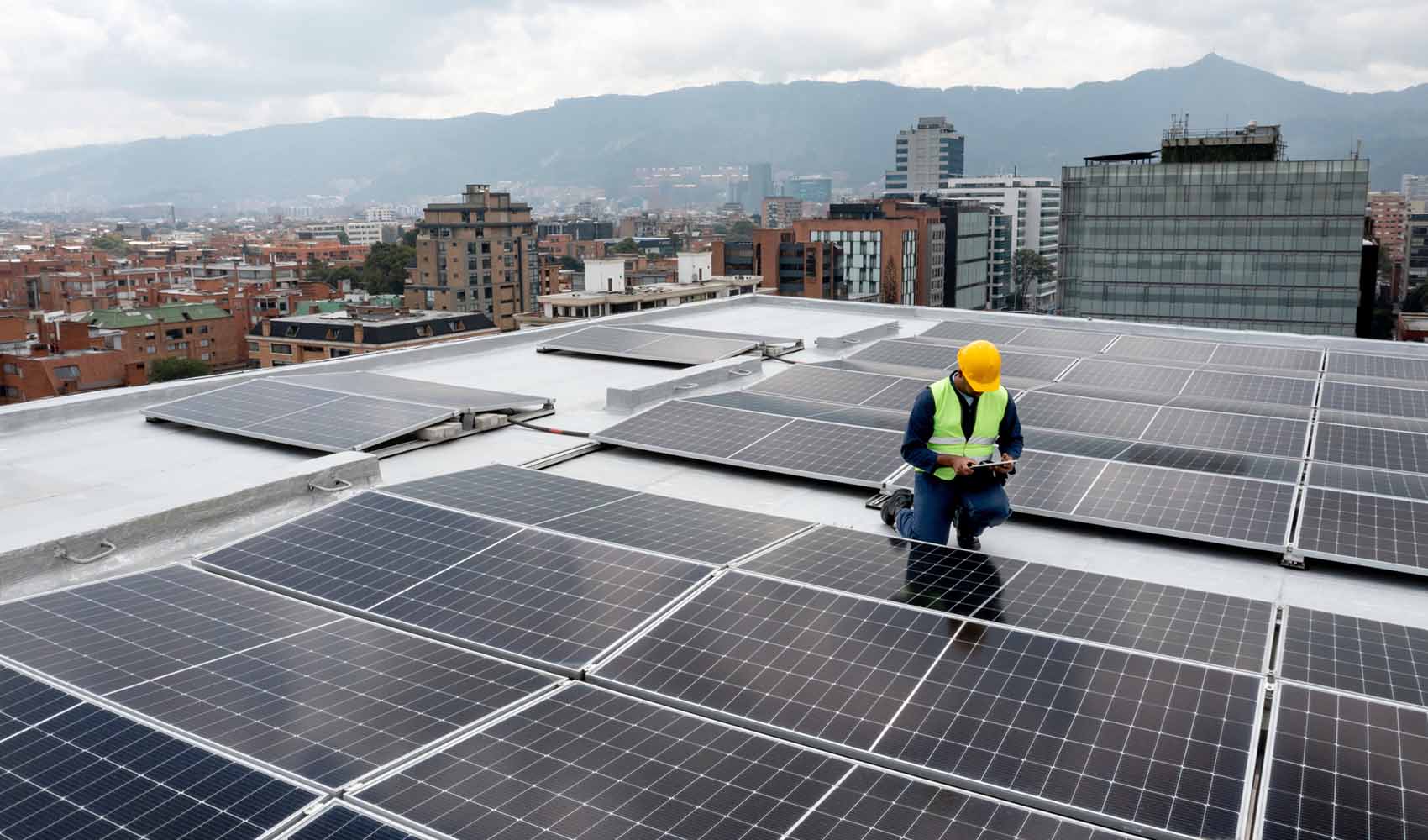 Person on a roof in the middle of solar panels