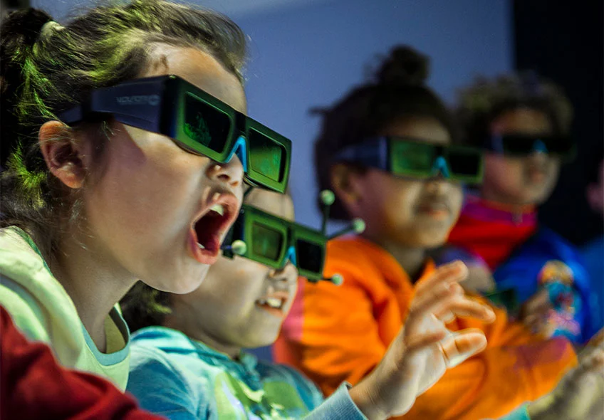 Photo of a group of children wearing 3-D visualization glasses.