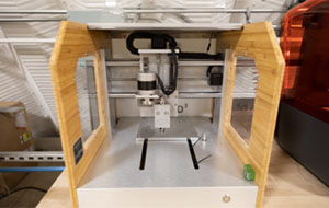 360tour-07-5541 A wooden frame houses a metal platform and a device that slides across metal rods.