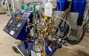 360tour-10-5342 Complex metal tubes and wires are intertwined next to a control panel.