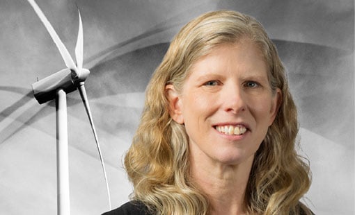 Amy Robertson in front of a wind turbine