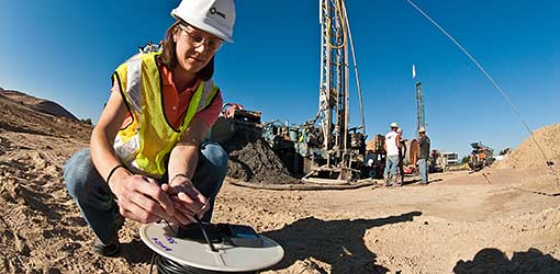 A researcher examines a heat sensor to make sure it's in working order.