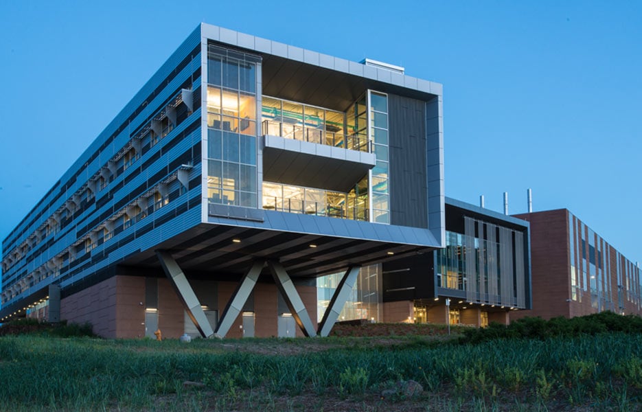 An evening photograph of the Energy Systems Integration Facility on NREL's campus.