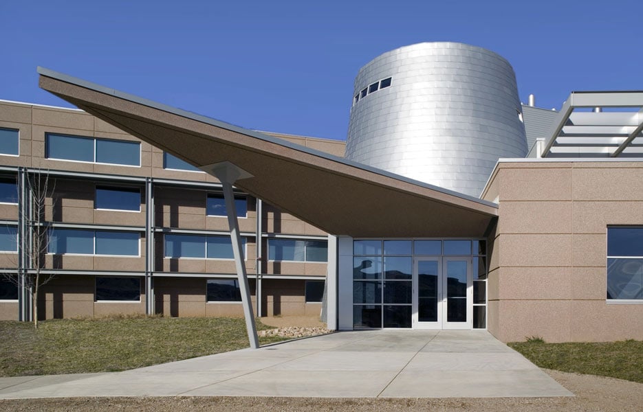 A modular building with a cylindrical metal structure in the middle.