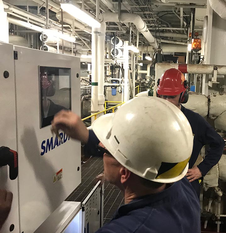 Cadets working on chiller on training ship.