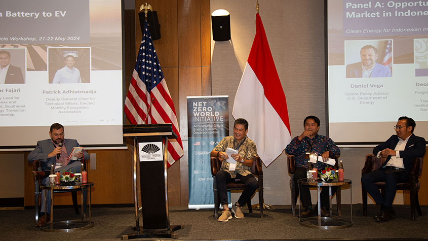 Four people sit on stage during panel discussion