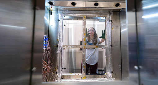 Person researching window efficiency in lab facility