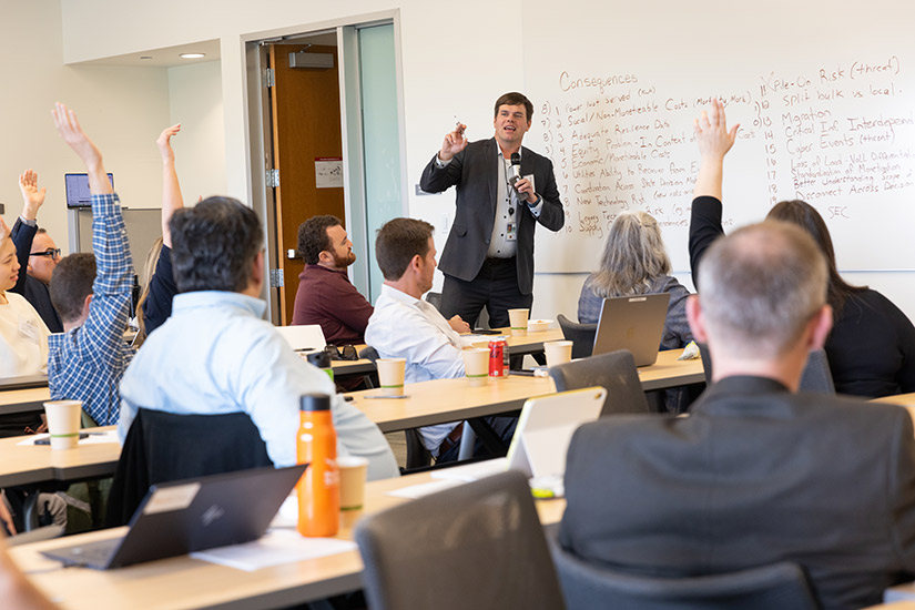 A presenter leads a workshop in a conference room.