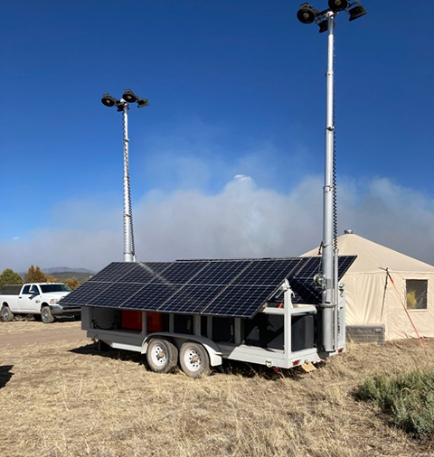 A hybrid trailer light tower deployed in a fire camp.