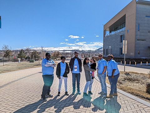 A group of people standing outside of the NREL campus.