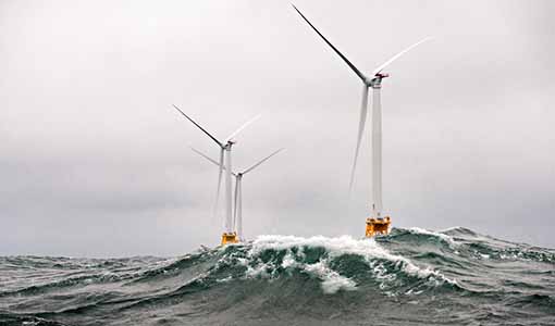 Offshore wind turbines weather a stormy sea.