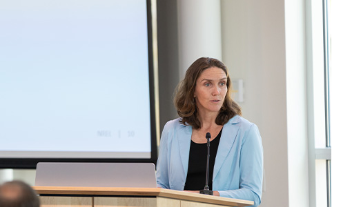 A woman at a podium giving a presentation.