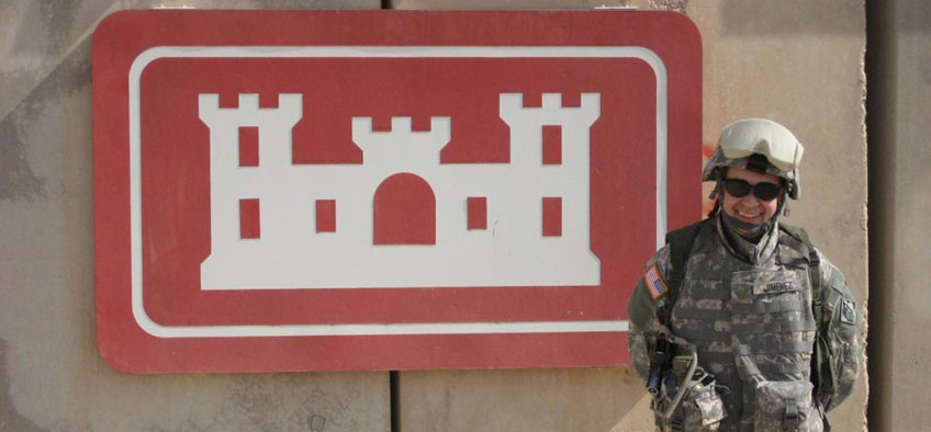Soldier stands in front of sign
