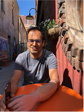 Jibo Sanyal sits at a table outside