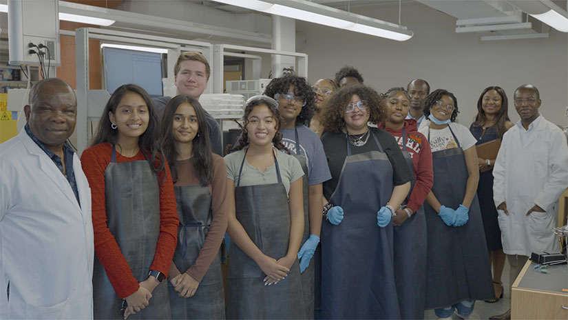 Group of people in aprons and labcoats