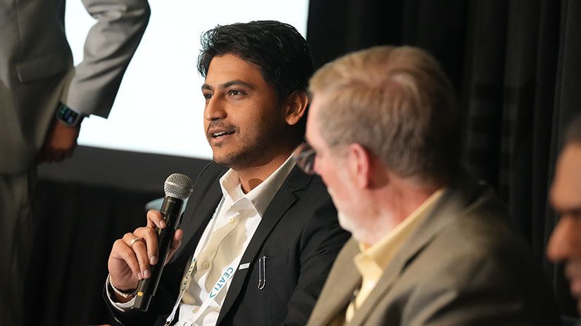 Person speaking into a microphone on stage