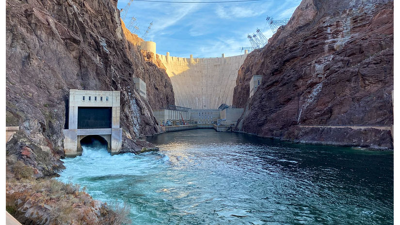 Looking upriver toward the Hoover Dam, with canyon walls on either side and blue sky above.