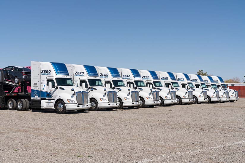 A fleet of zero-emissions trucks parked at a diagonal.