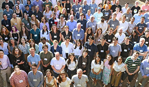 A large group of people gazing upward to pose for a photo