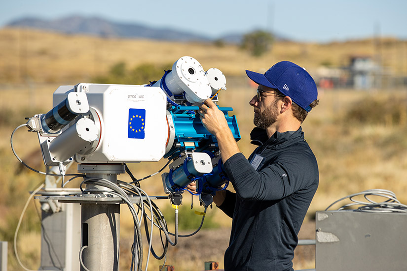 A person setting up solar alignment instruments outside.