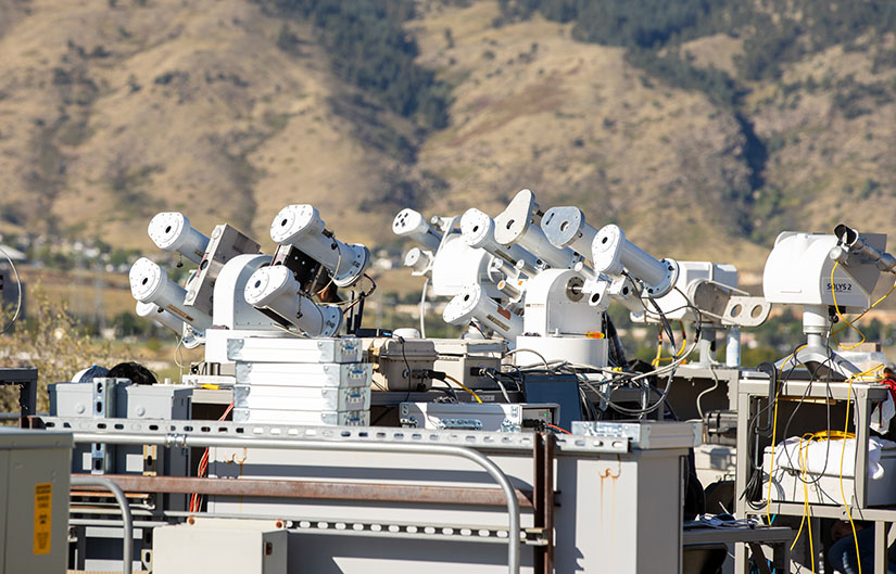 A large group of ACRs sit on a hilltop. 