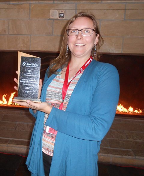 A person holding an award.