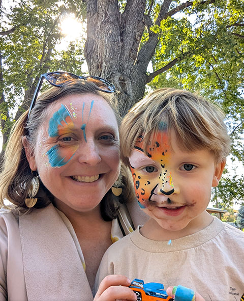 A person and a child with facepaint. 