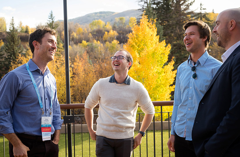 A group of people standing outdoors and talking.