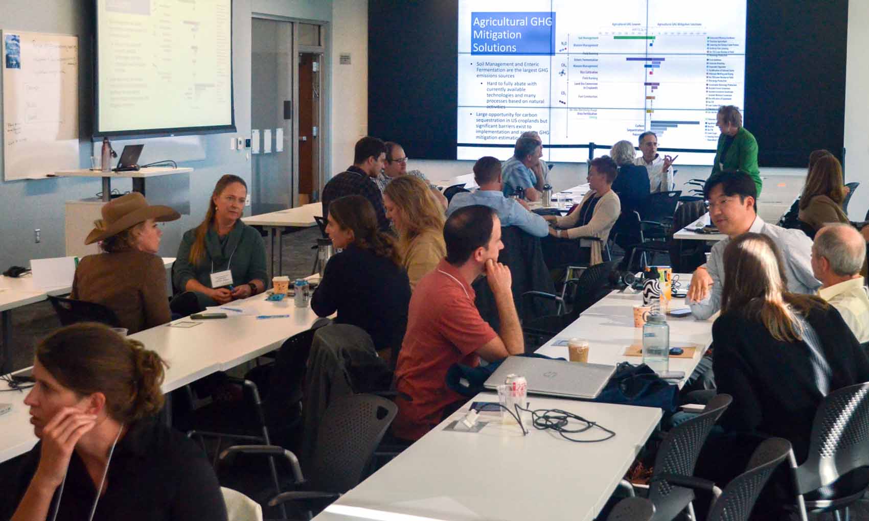 A group of people take part in a workshop in a conference room.