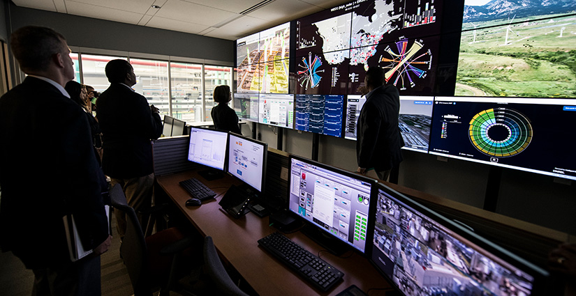 A tour group looks at the control room of the Energy Systems Integration Facility at the NREL South Table Mountain campus.