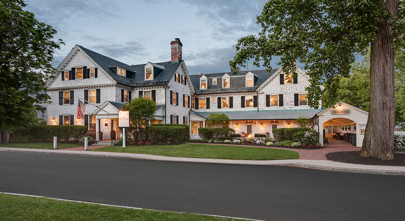 Exterior of a large, white, historic inn.