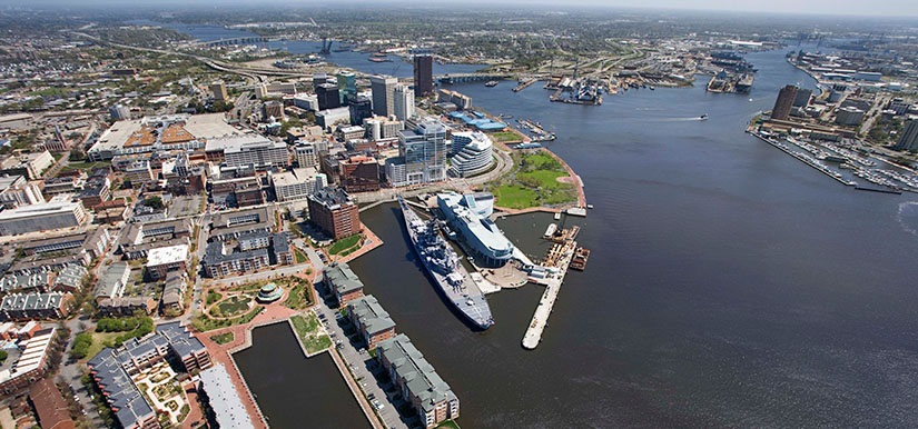 An aerial image of a city along a large waterway.