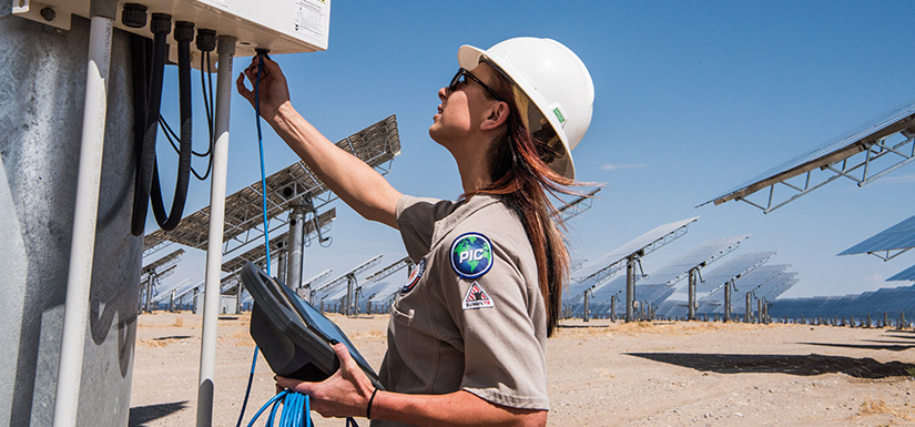 An employee running diagnostics on heliostats.