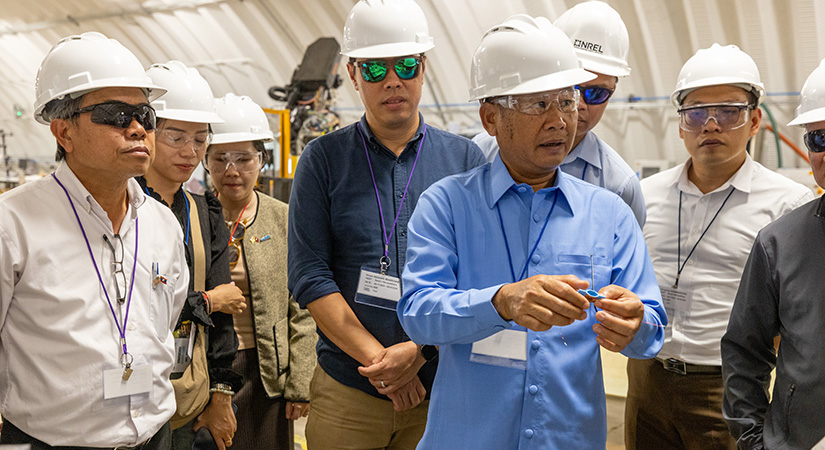 A large group of people wearing hard hats and safety goggles.