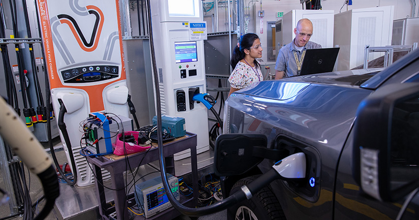 NREL researchers Namrata Kogalur and Keith Davidson run a battery charging test on a Ford F-150 Lightning.