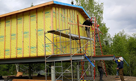 A crew at work rebuilding a home