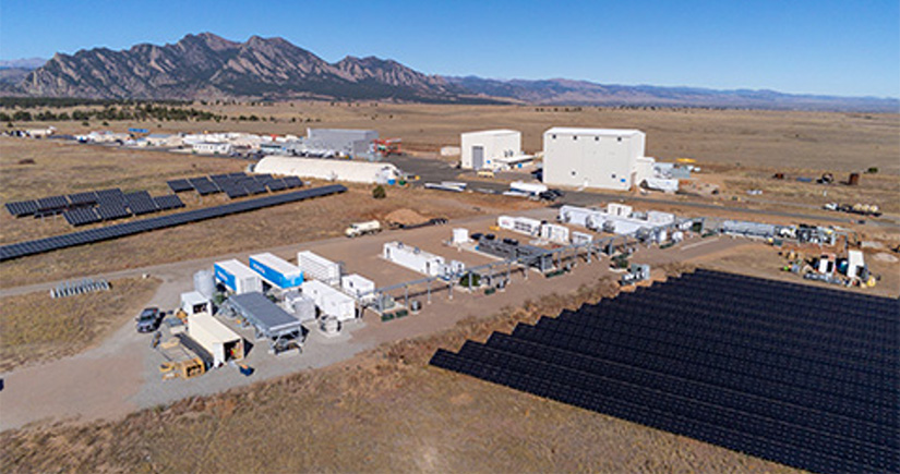 Aerial view of NREL's campus with energy storage buildings and solar arrays.